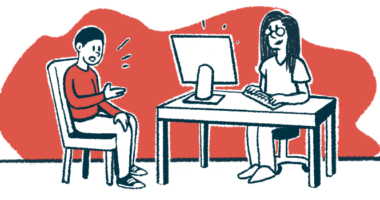 A doctor seated at a desk takes notes on their computer while a patient sitting in a chair speaks to them.