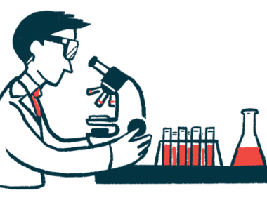 A researcher wearing safety goggles examines a sample using a microscope, alongside a rack of filled vials and a flask.