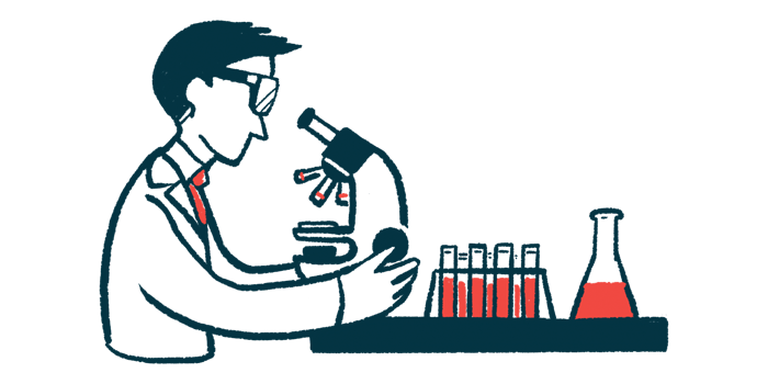 A researcher wearing safety goggles examines a sample using a microscope, alongside a rack of filled vials and a flask.