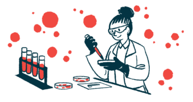 A scientist works with petri dishes in a lab alongside a rack holding four filled vials.