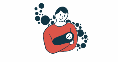 A parent is seen holding a sleeping baby.