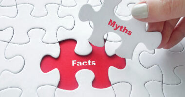 A puzzle with a hand removing a puzzle piece with 