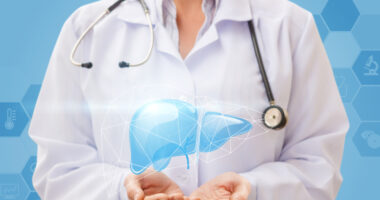 liver diagram being held in doctor's hands