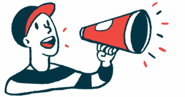 A young man in a baseball cap makes an announcement by speaking into a megaphone cone.