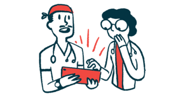 Two doctors view information on a tablet held by one of them.