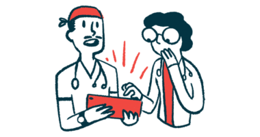 Two doctors view information on a tablet held by one of them.