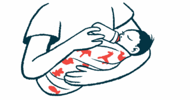 A woman cradles a baby in her arms as she feeds her from a bottle.