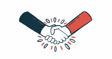Two people's hands are seen in a handshake.