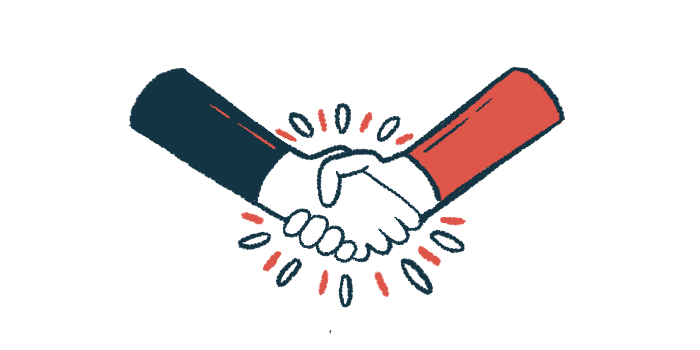 Two people's hands are seen in a handshake.
