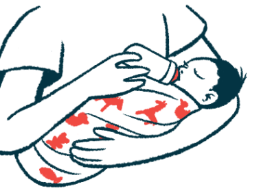 A baby in a person's arms drinks from a bottle.