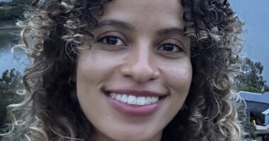 A woman smiles at the camera.