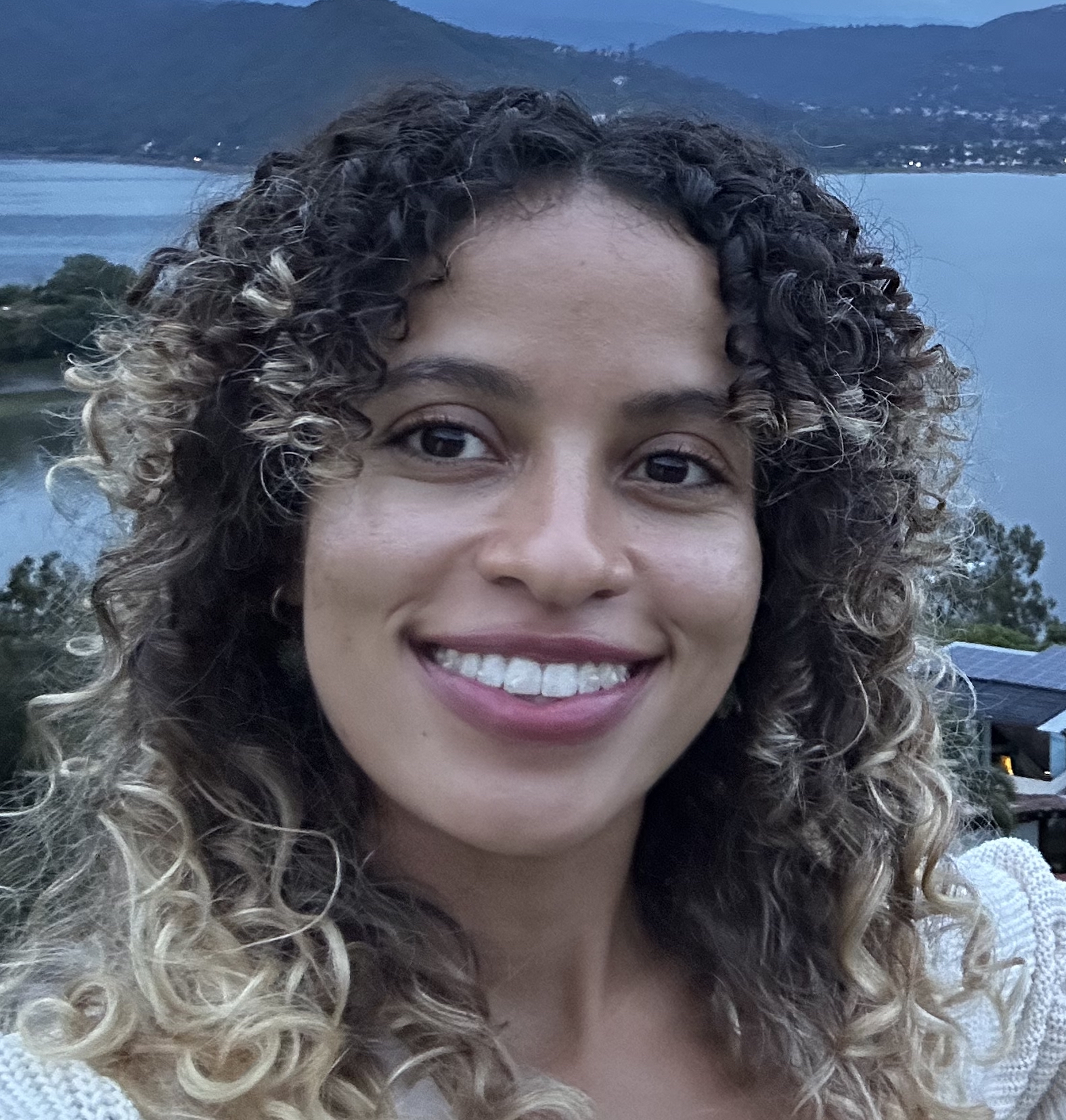 A woman smiles at the camera.